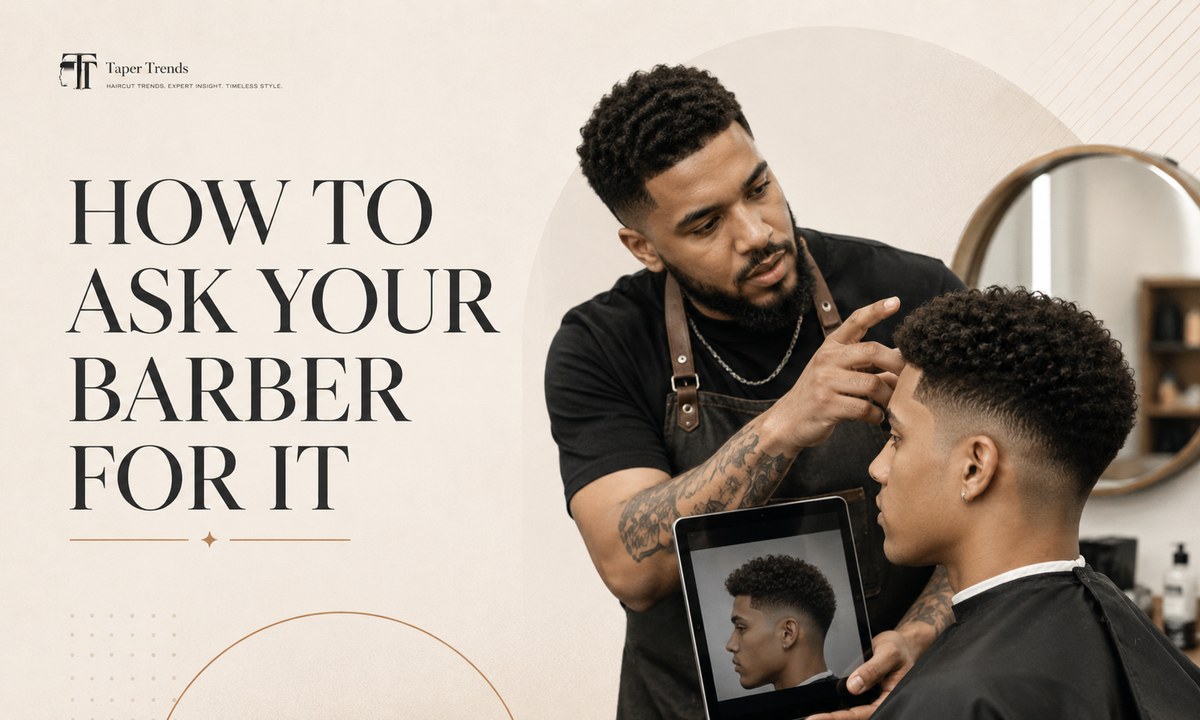 A barber tapering a low taper fade afro low near the ears while keeping the full afro shape on top.